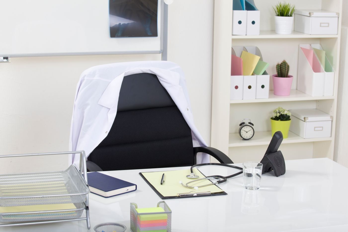 A consultation desk with a stethoscope and an empty chair
